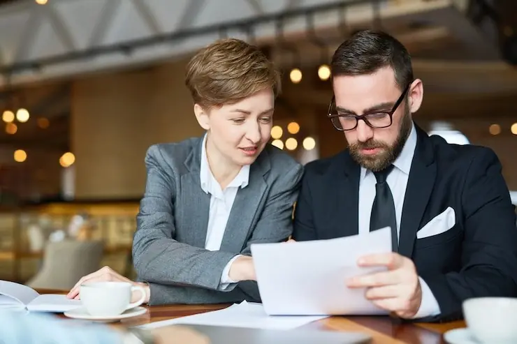 A colleague reading a short agreement over coffee