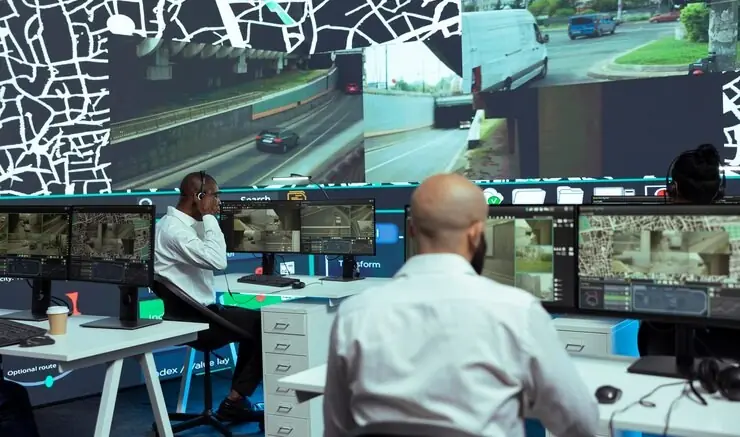 A security operations room with screens and staff at work